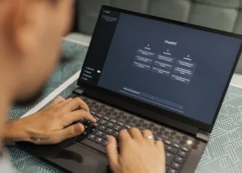 Freelancer using AI tools on laptop to make money online