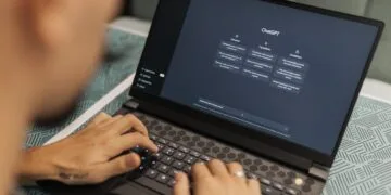 Freelancer using AI tools on laptop to make money online