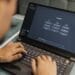 Freelancer using AI tools on laptop to make money online